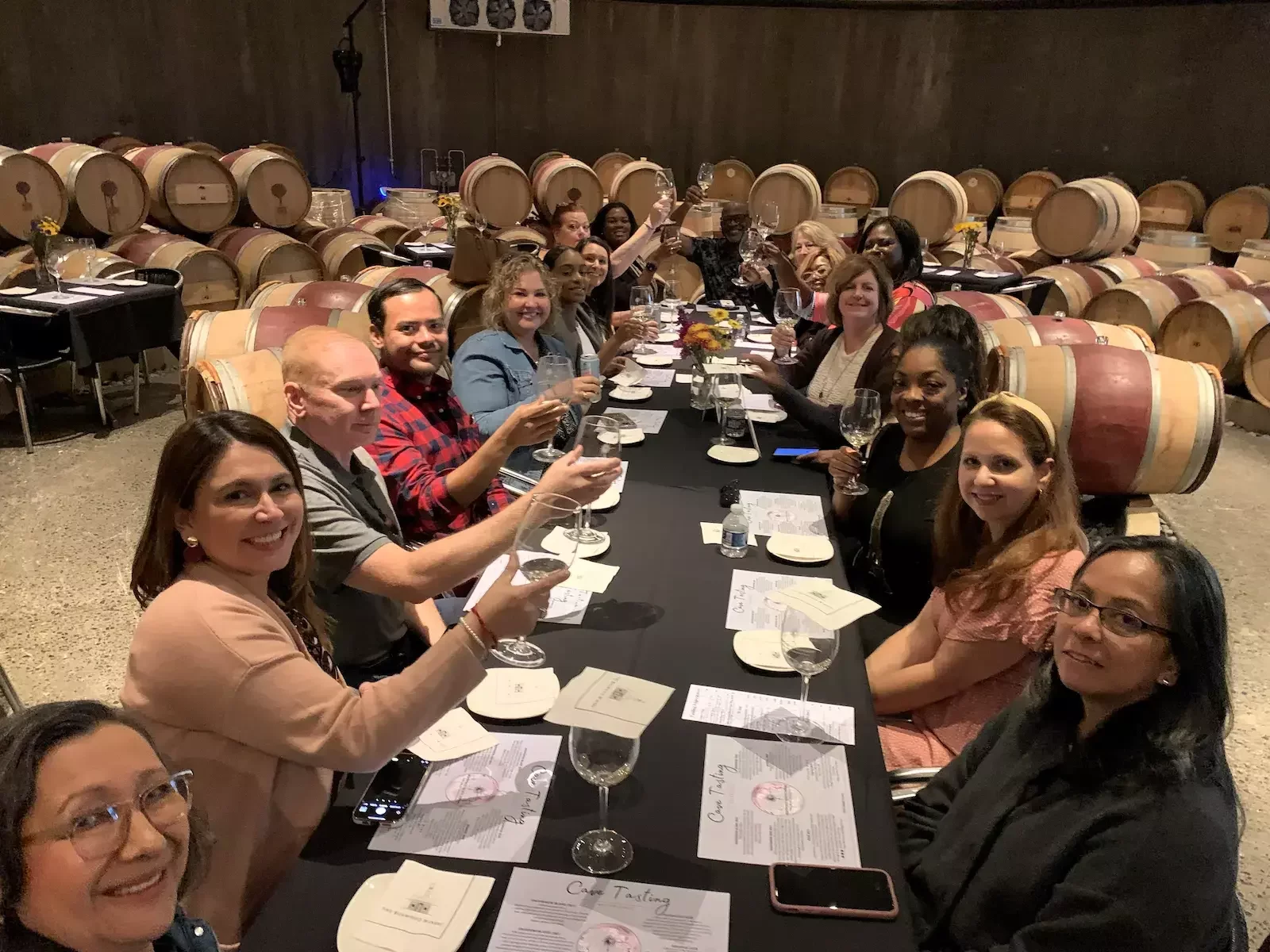 Corporate group seated for a private barrel room tasting and team outing at a Virginia winery.