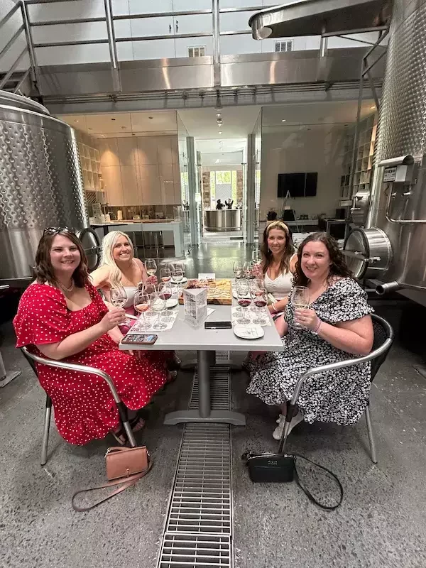 Guests enjoying a private wine tour lunch at Boxwood Winery Estate, surrounded by the elegant winery environment. This extended experience includes oven-warmed baguette sandwiches with imported French or Italian meats, chips, dips, and à la carte cheeses, creating a fresh, flavorful, and unforgettable moment during their wine journey.
