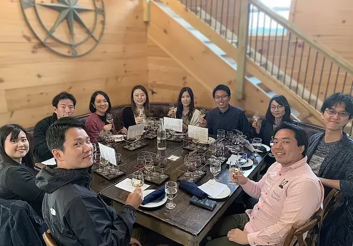 Private wine tour guests enjoying lunch and wine tasting at a Loudoun County winery, sharing local cuisine and conversation in a relaxed countryside setting.