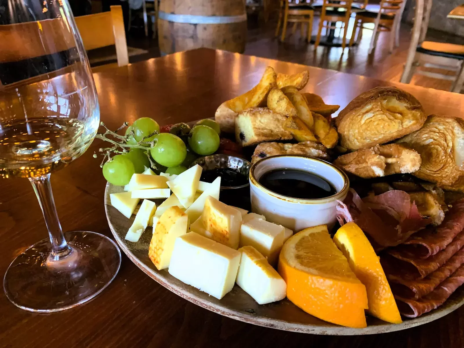 Sunday Funday Brunch Experience with wine and charcuterie at a Northern Virginia winery — red and white wine with grapes, cheese, and meats during a wine country tour.